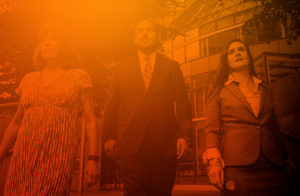 Three business people walking outside