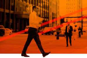 Man walking across a city street
